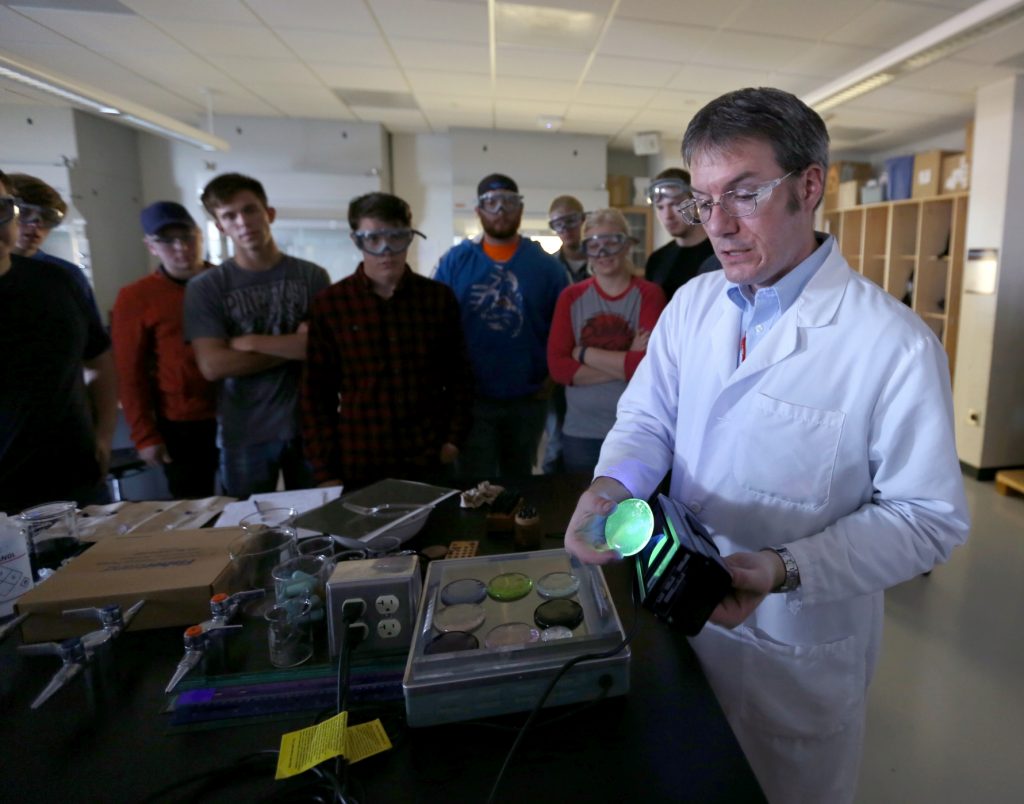 Students work in the lab during Associate Professor Matthew Ray's Chemistry of Materials class An engineering student works on mathematics coursework in Jarvis Hall Thursday, September 28, 2017. Pictured is the class comparing amorphous glass behavior with the crystalline solid behavior observed in the first part of the lab. They prepared batches of soda lime glass and varied the ingredients to change the melt viscosity and color. Glasses of various colors were prepared by adding small amounts of metal oxides to the glass mixture before firing to melt and react all of the ingredients together. The glass mixtures were placed into crucibles and heated overnight to 1150°C (2100°F), then poured onto an iron slab and allowed to cool. To observe fluorescence, the europium and terbium doped samples were illuminated with an ultraviolet lamp (365 nm light) which revealed the bright red and green fluorescence. (UW-Stout Photo by Brett T. Roseman)