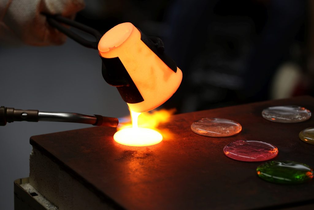 Students work in the lab during Associate Professor Matthew Ray's Chemistry of Materials class An engineering student works on mathematics coursework in Jarvis Hall Thursday, September 28, 2017. Pictured is the class comparing amorphous glass behavior with the crystalline solid behavior observed in the first part of the lab. They prepared batches of soda lime glass and varied the ingredients to change the melt viscosity and color. Glasses of various colors were prepared by adding small amounts of metal oxides to the glass mixture before firing to melt and react all of the ingredients together. The glass mixtures were placed into crucibles and heated overnight to 1150°C (2100°F), then poured onto an iron slab and allowed to cool. To observe fluorescence, the europium and terbium doped samples were illuminated with an ultraviolet lamp (365 nm light) which revealed the bright red and green fluorescence. (UW-Stout Photo by Brett T. Roseman)